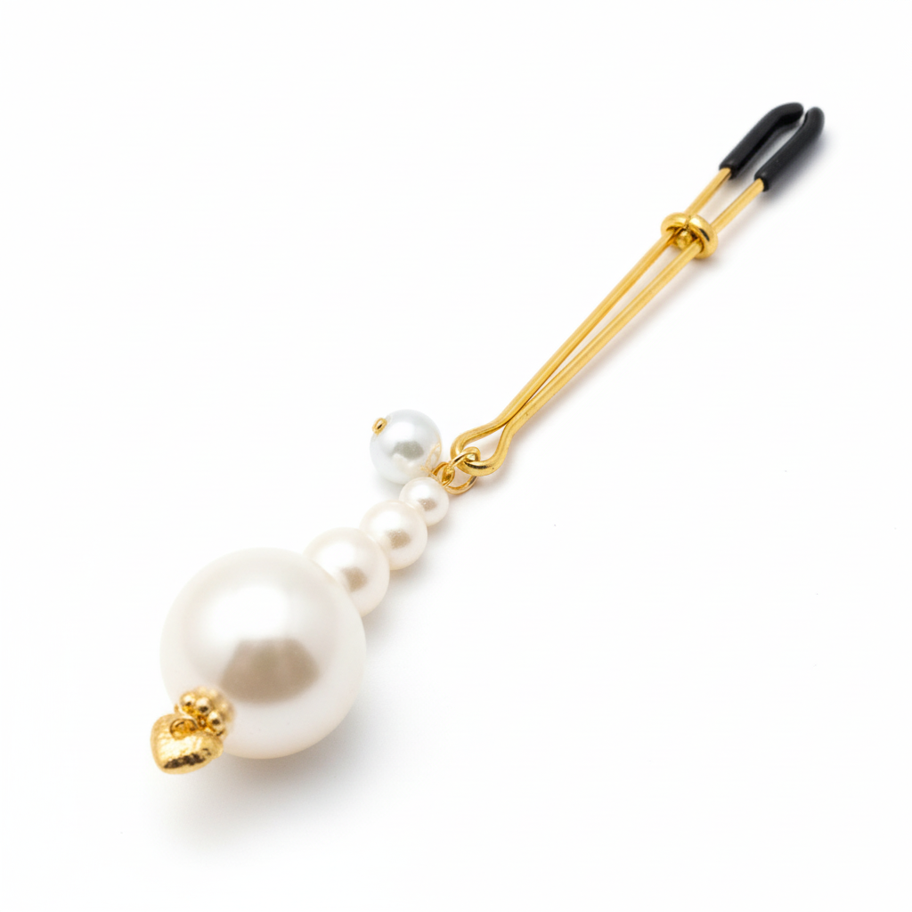 Parel tepelklem close-up - detail van parels en gouden bedel