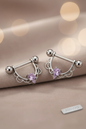 Tepel piercings met roze zirkonia