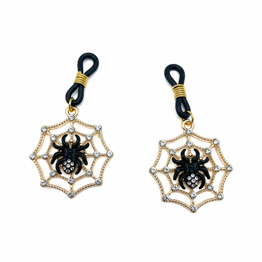 Spinnenweb tepelhangers met zwarte spin en kristallen op witte achtergrond