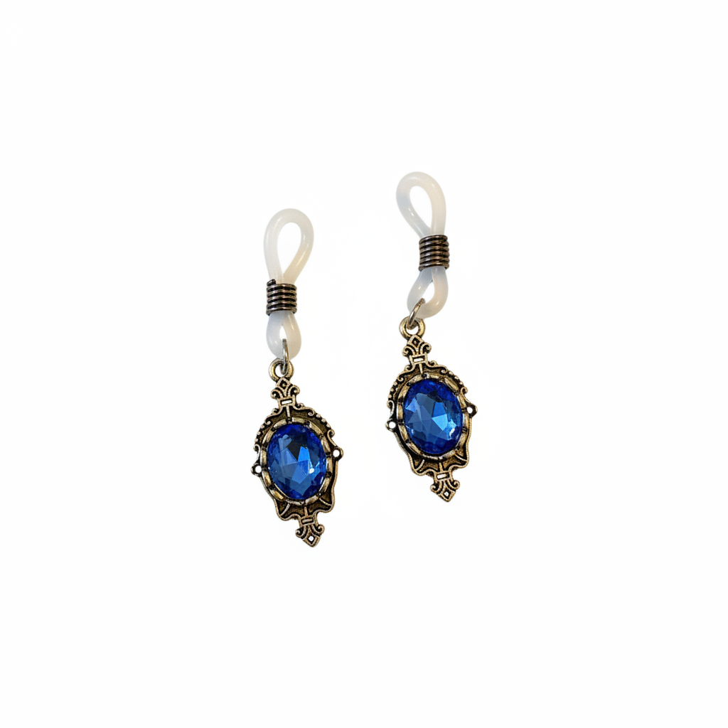 Vintage tepelhangers met blauwe kristallen in goudkleurige zetting